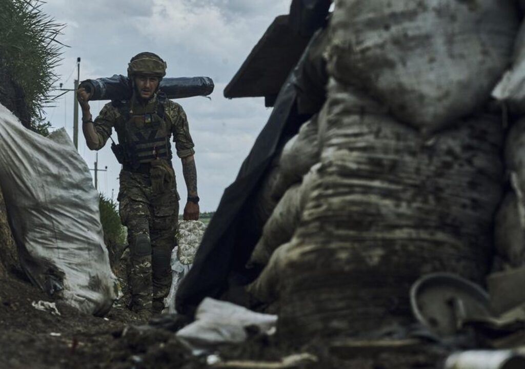 A Ukrainian soldier carries supplies in a trench at the frontline near Bakhmut in the Donetsk region, Ukraine, Monday, May 22, 2023. (AP Photo/Libkos)