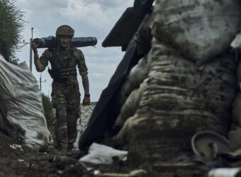 A Ukrainian soldier carries supplies in a trench at the frontline near Bakhmut in the Donetsk region, Ukraine, Monday, May 22, 2023. (AP Photo/Libkos)